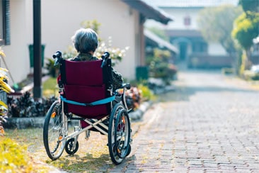 elderly woman in wheelchair by herself