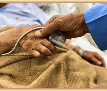 holding elderly hand nursing home
