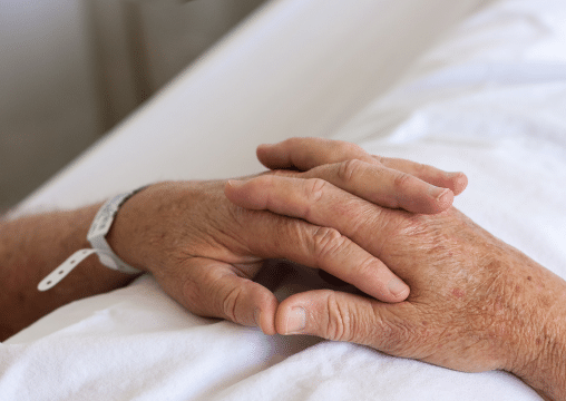 A patient holding his hands together